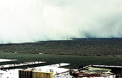 A lake-effect snow storm with freezing temperatures produces a wall of snow travelling over Lake Erie into Buffalo on Wednesday