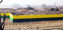 An aerial view of the Bhagtanwala dumpyard, partially covered by a boundary wall in Amritsar