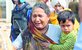 A follower of Rampal cries as she leaves Satlok Ashram at Barwala in Hisar district on Thursday.