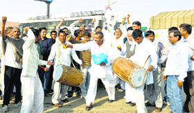 Villagers distribute sweets at Dighal village in Jhajjar on Thursday.