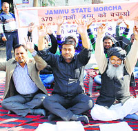 Activists of the Jammu State Morcha protest in Jammu on Thursday.