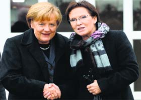 German Chancellor Angela Merkel (L) and Poland's Prime Minister Ewa Kopacz shake hands before talks in Krzyzowa, Poland, on Thursday, where they met to mark 25 years since a symbolic reconciliation between Poland and Germany whose ties were marked by warfare in the past