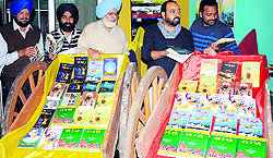 Kewal Dhaliwal and poet Parminderjit inaugrate a book exhibition at Virsa Vihar in Amritsar on Friday