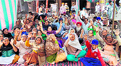 Residents living in localities near the Bhagtanwala dumpyard continue their protest in Amritsar on Friday