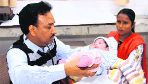 Dr Satish Jindal examines a new-born girl who was found in the cradle outside Mahant Gurbant Dass School for Deaf and Dumb in Bathinda on Friday.