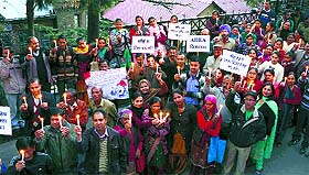 Employees of the LIC hold a candlelight march in Shimla on Friday. 