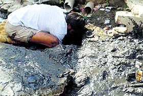 A worker cleans a sewer without safety guard in Jagraon 