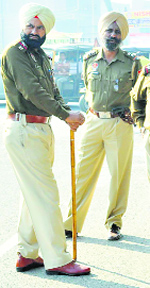 Policemen stand guard outside the main gate.