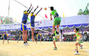 A player of Uttarakhand (green) smashes the ball during a match against Uttar Pradesh (blue) in the 60th National School Volleyball Tournament at Pavilion Ground in Dehradun on Friday.