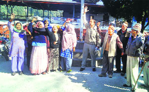 Retired Municipal Council employees hold a protest in Mussoorie on Friday.