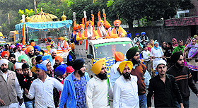 Devotees take part in a nagar kirtan on the eve of martyrdom day of Guru Tegh Bahadur in Chandigarh on Saturday.