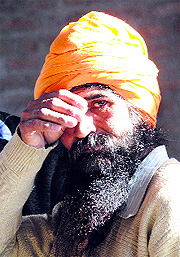 Daljit Singh waits for the body of his son Harminder Singh at his residence. 