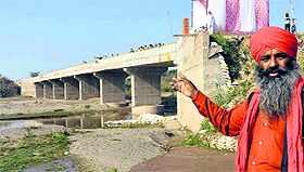 Godman Gafur shows the bridge constructed by residents of Amlala village. 