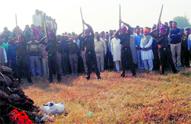 Policemen fire in the air to pay tributes to Kuldeep Singh at Ramgarh village in Karnal on Saturday.