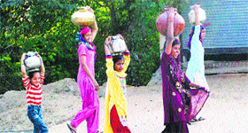 Women and children fetch water at Bolni village in Rewari.