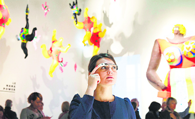 A woman wears Google glass as she visits an exhibition dedicated to the work of French artist Niki de Saint Phalle at the Grand Palais in Paris.