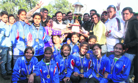 Players of the Haryana girls team with the trophy of the Under-17 National School Volleyball Tournament at Pavilion Ground in Dehradun on Saturday.