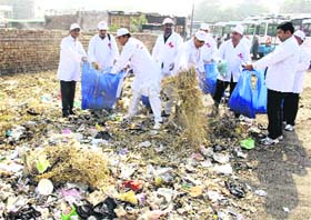 Members of the Human Rights Protection take part in a cleanliness drive. 