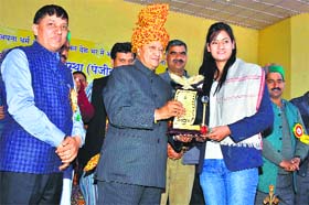 Chief Minister Virbhadra Singh honours an awardee at Sujanpur in Hamirpur on Sunday