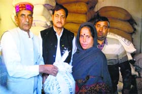MLA Sohan Lal Thakur distributes ration after inaugurating a fair price shop at Sohar village in Sundernagar on Sunday