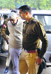 Policemen take Sant Rampal to the Civil Hospital in Hisar on Sunday