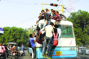 Students risk their lives by riding a fully packed bus in Hisar on Sunday
