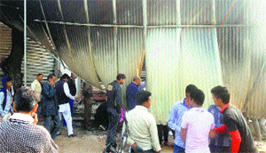People at the spot of the fire in Hathin on Sunday