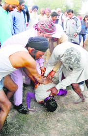Villagers try to revive a boy in Kaithal on Sunday.