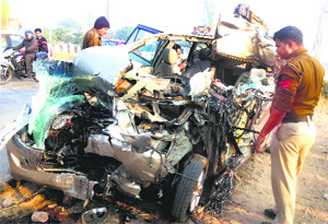 The mangled remains of an Innova car after it crashed into a stationary truck in Palwal on Sunday