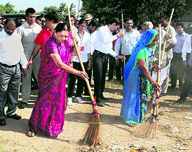 Gujarat CM Anandiben Patel cleans up a village in Ahmedabad on Sunday. 
