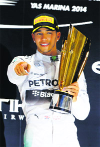 Lewis Hamilton celebrates on the podium after winning the Abu Dhabi Grand Prix. AFP 