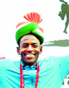 Guye Adola celebrates after his win in the elite category.