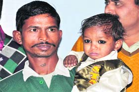Two-year-old Akash at a press conference at the SSP office in Dehradun on Sunday