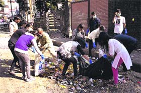 MAD activists clear garbage at Jakhan area in Dehradun on Sunday