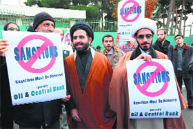 Iranians hold placards during a demonstration outside the Tehran reactor to show their support to Irans nuclear programme