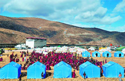 Tibetan residents gather outside makeshift tents at a relief centre in Kangding;