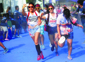Participants run during the Colour Run in Jakarta on Sunday. Dubbed The Happiest 5k on the planet, the run is a five-km event that sees participants go through colour stations where they are doused with colours