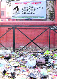 A heap of garbage is placed before a bunting, announcing  the Swachh Bharat Abhiyan on the Majitha road in Amritsar on Monday.
