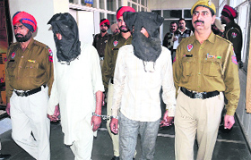 The father-son duo that was arrested for drug smuggling in police custody in Bathinda on Monday.
