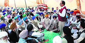 Dewinder Sharma, an economist, addresses members of the BKU near YPS Chowk in Mohali on Monday. 