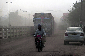 Vehicles ply on a damaged road at Bhankharpur village near Dera Bassi on Monday. 