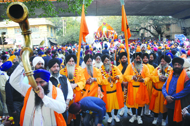 Sikh devotees dress up as Panch Pyare at a nagar kirtan to mark the martyrdom day of Guru Teg Bahadur, organised by DSGMC in New Delhi on Monday.