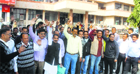 Applicants protest outside the HUDA office in Karnal on Monday.