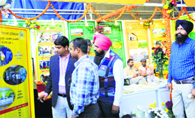 Visitors have a look at posters during Agro-Tech 2014 in Chandigarh on Monday.