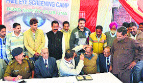 Drivers get their eyes checked at a camp in Una on Monday.