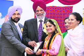 Minister of Higher Education and Languages Surjeet Singh Rahkra honours a student during the annual prize distribution function at the Lyallpur Khalsa College for Education in Jalandhar