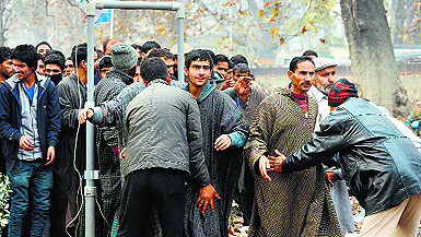 Policemen screen people before an election rally in Srinagar on Monday. 