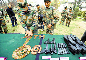 The Army displays arms and ammunition recovered from poll-bound Kupwara district, in Srinagar on Monday. 