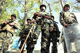 Security personnel stand guard ahead of the first phase of the elections in Kishtwar on Monday. 