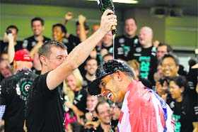 Hamilton has champagne poured on his head in Abu Dhabi